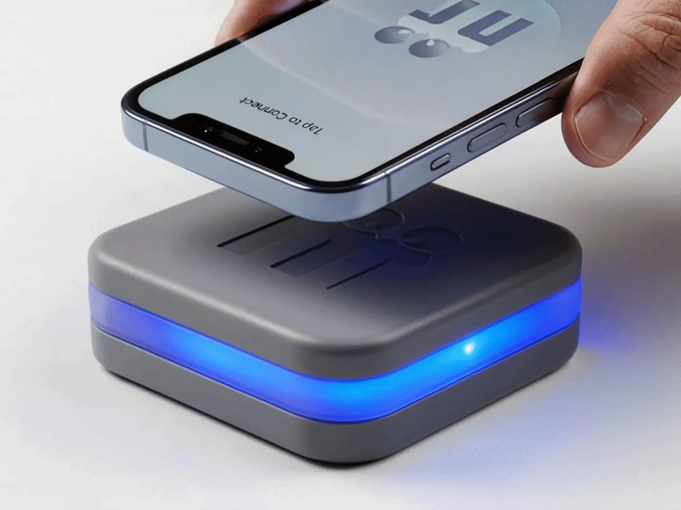 A hand holding a phone just above The Cookie, whose light ring is lit blue.
